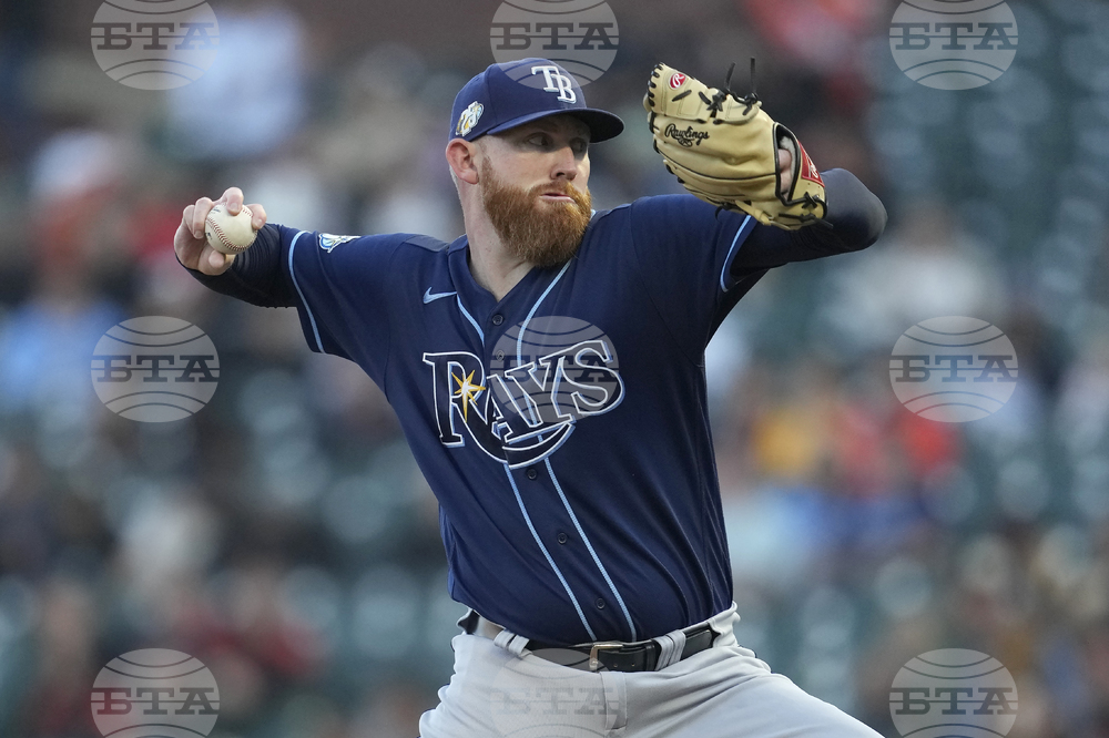 Tampa Bay Rays' Randy Arozarena, left, is tagged out by San Francisco  Giants first baseman LaMonte Wade Jr. during the first inning of a baseball  game in San Francisco, Monday, Aug. 14