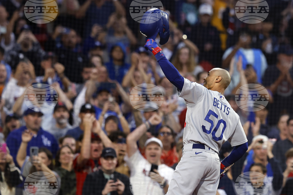 Los Angeles Dodgers' Freddie Freeman (5) scores behind Boston Red Sox  catcher Connor Wong on a sacrifice fly by David Peralta during the ninth  inning of a baseball game, Friday, Aug. 25