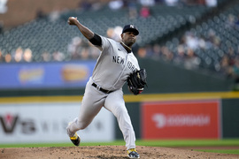 New York Yankees relief pitcher Jonathan Loaisiga, left, congratulates  third baseman Oswaldo Cabrera, right, on his catch of a Detroit Tigers'  Riley Greene line drive in the eighth inning of a baseball