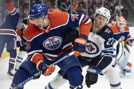 Winnipeg Jets' Mason Appleton (22) battles for the puck with Edmonton Oilers'  Vincent Desharnais (73) during the first period of an NHL preseason hockey  game in Edmonton, Alberta on Sunday, Sept. 24