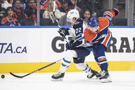 Winnipeg Jets' Mason Appleton (22) battles for the puck with Edmonton Oilers'  Vincent Desharnais (73) during the first period of an NHL preseason hockey  game in Edmonton, Alberta on Sunday, Sept. 24